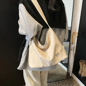 Retro cream large capacity tote bag with stylish metal buckle shown on shoulder