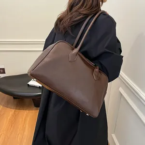 Detailed view of deep brown vintage tote bag with high-gloss finish and long handles