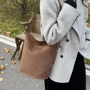 Close-up of brown frosted suede bucket bag featuring high-quality vintage texture