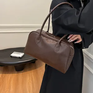 Deep brown leather vintage tote bag shown worn on shoulder with a classic retro texture