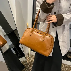 Brown retro leather tote bag shown from side and front mirror view for styling