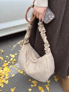 Chic quilted puffer hobo bag in cream white featuring a stylish textured finish