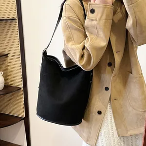 Chic black suede-textured bucket bag for women featuring a spacious commuter shoulder design