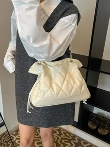 Quilted cream tote bag with gold chain straps and large capacity for daily use
