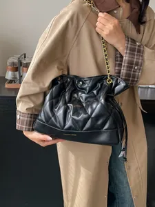 Quilted black chain bucket bag with cloud-style pleated design and metallic strap