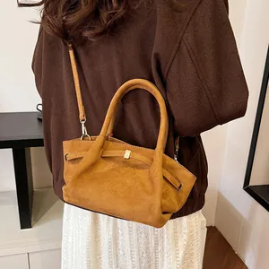 Caramel suede tote bag featuring natural pleats, smooth round handle and metallic buckle