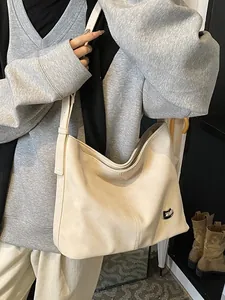 Minimalist beige hobo tote bag in soft leather with silver buckle for casual daily wear