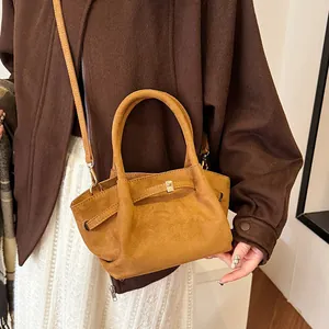Deep caramel brown tote bag in matte suede texture shown on model for autumn outfit style