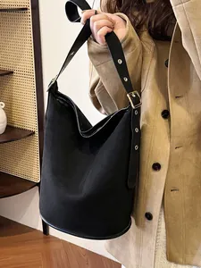 Women's black matte suede bucket bag with wide adjustable metal buckle shoulder strap