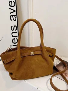 Vintage brown faux suede tote bag with gold metal buckle and adjustable shoulder strap