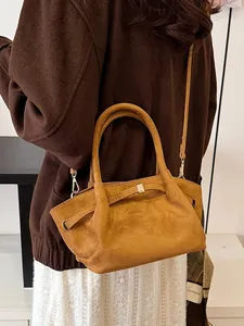 Vintage brown suede tote bag for women featuring curved handles and shoulder strap