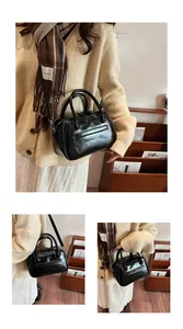 Three-way view of a black oil-wax leather Boston bag used as crossbody and handbag