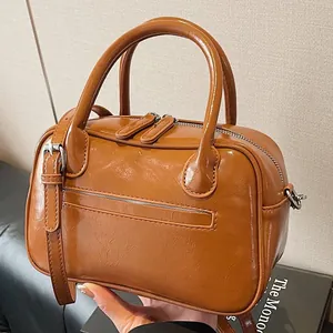 Vintage caramel brown leather tote bag with glossy finish and silver hardware details
