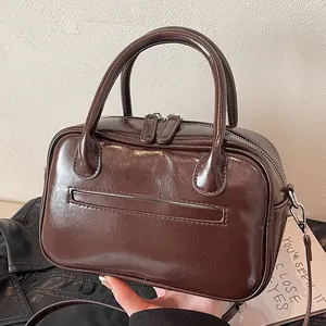 Vintage dark brown oily leather tote bag with top handles and adjustable shoulder strap