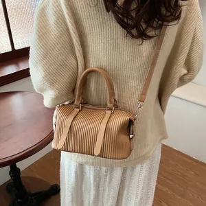 Vintage pleated light brown bucket bag with top handles and adjustable shoulder strap