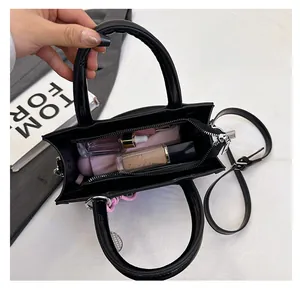 Top view of black tote interior showing compartments for cosmetics and makeup essentials