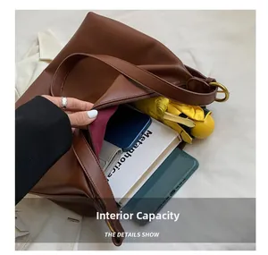 Detail view of large brown leather tote bag interior showing spacious storage capacity