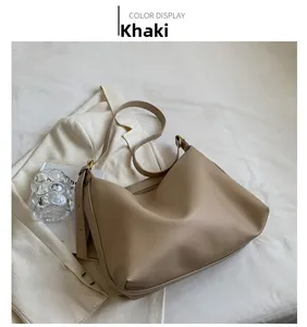 Detail view of khaki large capacity tote bag with adjustable strap and zipper closure