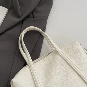 Close-up of white lychee pattern leather tote bag showing fine stitching and luxury texture