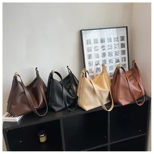 Detailed view of large hobo tote bags in four colors with gold ring accents and wide straps
