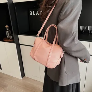 Detailed close-up of pink lychee textured tote bag with adjustable shoulder strap and hardware