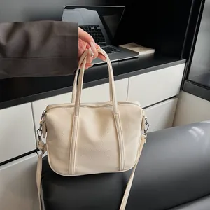 Detailed macro view of cream-colored pebble leather texture and silver metal buckles