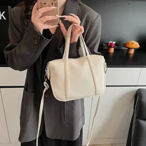 Detailed macro view of white lychee pattern faux leather handbag with detachable strap