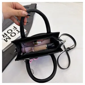 Detail view of the black PU leather tote bag showing spacious interior for daily cosmetics