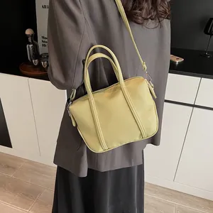 Close-up of a light green lychee textured leather handbag styled in a modern interior