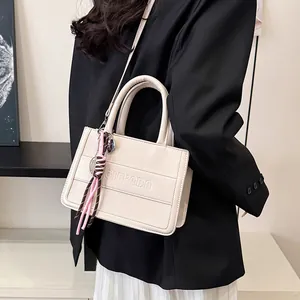 Creamy PU leather tote bag with embossed letters and decorative knot pendant