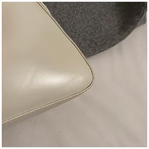 Detailed macro view showing premium ivory leather texture and smooth black edge paint finish