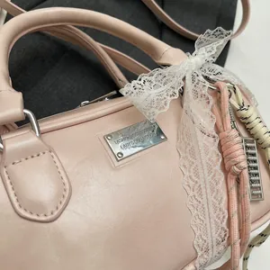 Detail of pink vintage bowling bag with lace bow and silver fashion nameplate