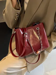 Elegant burgundy glossy leather tote bag with silver chain and shoulder strap for women