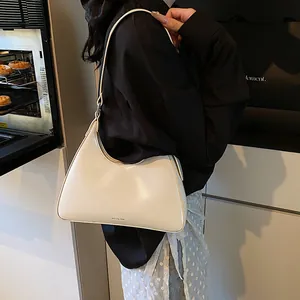 Detail of a minimalist white hobo bag with NO FILTER text shown in a lifestyle kitchen setting