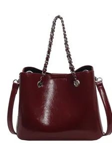 Burgundy glossy faux leather bucket bag with silver chain handle and shoulder strap