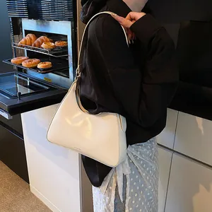 Chic cream leather underarm bag featuring delicate NO FILTER text on bottom side