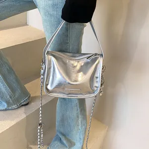 Detail of silver metallic handbag with pleated texture and stylish chain strap detail