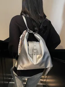 Silver metallic minimalist backpack with a decorative silk scarf for modern women