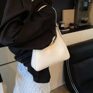 Detail of cream white underarm bag in premium PU leather with NO FILTER lettering logo