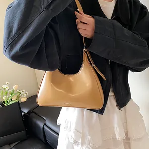 Shoulder bag in brown glossy leather with NO FILTER logo shown on female model