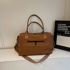 Detail of vintage brown leather travel bag with durable straps and luggage sleeve