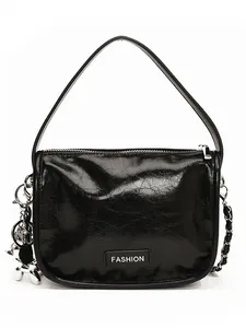 Fashionable black patent leather shoulder bag with silver chain and dog charm detail