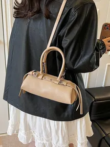 Fashionable beige cylindrical baguette bag with silver buckles for trendy women