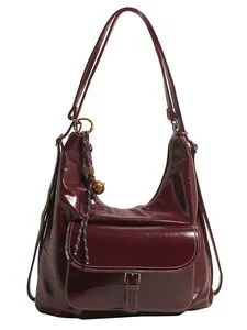 Deep burgundy glossy hobo shoulder bag with white contrast stitching and gold metal hardware