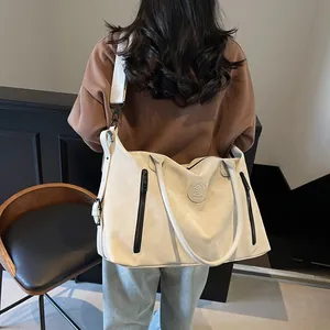 Detailed back view of a large cream white sports bag with black zippers and shoulder strap