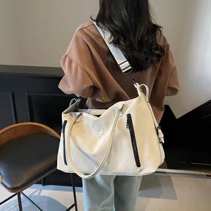 Large capacity off-white travel tote bag with black zipper detail and shoulder strap