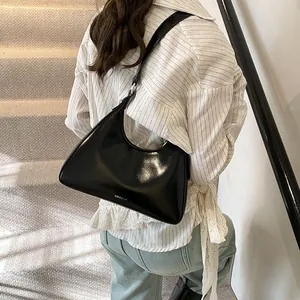 Close-up of black glossy patent leather shoulder bag featuring NO FILTER logo print