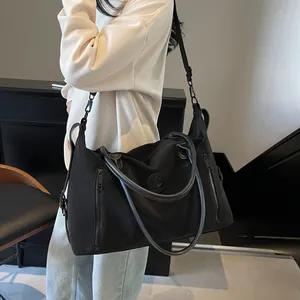 Detail view of large capacity black nylon fitness bag with adjustable shoulder straps