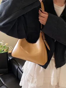 Minimalist camel brown hobo underarm bag in smooth PU leather with adjustable strap