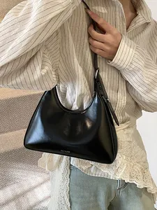 Minimalist black patent leather hobo bag with white NO FILTER print and moon shape